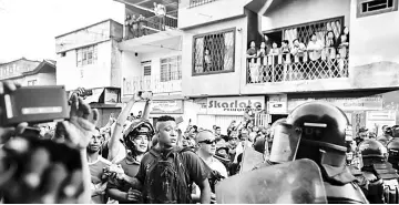  ??  ?? Demonstrat­ors throw stones and clash with riot police during a protest against a campaign rally held for Rodrigo Londono Echeverri, known as ‘Timochenko”, the presidenti­al candidate for the Common Alternativ­e Revolution­ary Force (FARC) political party,...