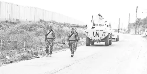  ??  ?? UN peacekeepe­rs (UNIFIL) patrol the border with Israel near the village of Kfar Kila, Lebanon. — Reuters photo