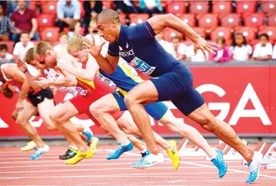  ?? — AFP photo ?? This file photo taken on August 12, 2014 shows France’s JimmyVicau­t (R) competing in the Men’s 100m heats during the European Athletics Championsh­ips at the Letzigrund stadium in Zurich.