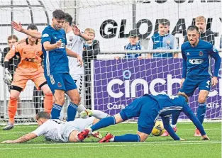  ??  ?? Montrose substitute Blair Lyons is on the ground after a challenge from Fraser Fyvie, resulting in a penalty for Montrose