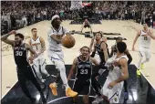  ?? ERIC GAY — THE ASSOCIATED PRESS ?? Spurs guard Tre Jones (33) and teammates celebrate the winning score against the Nuggets during the second half of Friday's game in San Antonio.