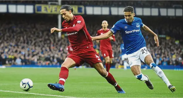  ?? — AP ?? He’s too fast: Liverpool’s Virgil van Dijk (left) in action against Everton’s Dominic Calvert-Lewin during the English Premier League match at Goodison Park on Sunday.