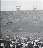  ?? AP PHOTO ?? Spectators fill the Coliseum during the fourth game of the World Series in Los Angeles, Oct. 5, 1959.