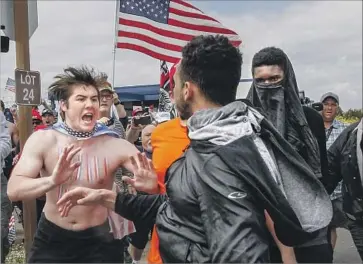  ?? Irfan Khan Los Angeles Times ?? A SCUFFLE BREAKS out during a Make America Great Again rally at Bolsa Chica State Beach in March. The event had been billed as a march to support first responders, military veterans and President Trump.