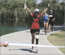  ?? AP PHOTO/ROSS D. FRANKLIN ?? Jacky Hunt-Broersma finishes her 102nd marathon in 102 days, this one at Veterans Oasis Park, on April 28 in Chandler, Ariz.