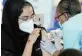  ??  ?? SAFER: Healthcare workers are vaccinated at Chris Hani Baragwanat­h Hospital in Soweto, Johannesbu­rg, on Wednesday.