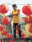  ?? SAKCHAI LALIT/ THE ASSOCIATED PRESS ?? A Thai worker decorates lanterns for celebratio­ns of Chinese New Year at the Leng Nuei Yee Chinese temple in Bangkok, Thailand, on Wednesday.