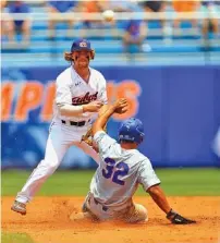  ?? THE ASSOCIATED PRESS ?? Auburn second baseman Luke Jarvis throws to first base to complete a double play during Sunday’s super regional game against Florida in Gainesvill­e. Jarvis hit an RBI single in the bottom of the ninth inning to lift the Tigers to a 3-2 win and force a deciding third game today.