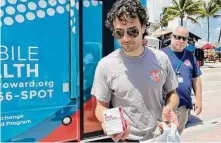  ?? Freida Frisaro / Associated Press ?? Counselor Huston Ochoa hands out samples of Narcan to spring breakers in Fort Lauderdale, Fla., on March 31.