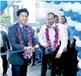  ??  ?? Softlogic Holdings PLC Chairman/md Ashok Pathirage and Samsing Sri Lanka Managing Director Hanbae Park cut the ribbon to declare open the Experience Store