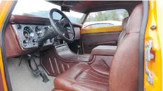  ??  ?? The interior of Ron Tkachuk’s 1971 GMC truck features a lower centre console and is trimmed all in brown leather.