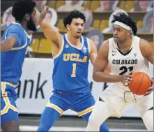  ?? DAVID ZALUBOWSKI — THE ASSOCIATED PRESS ?? UCLA’s Jules Bernard (1) and Cody Riley, left, trap Colorado’s Evan Battey during a Pac-12 game last month in Boulder, Colo.