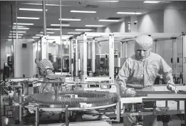  ?? PROVIDED TO CHINA DAILY ?? Santen employees work at a production facility in Suzhou, Jiangsu province.