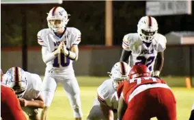  ??  ?? Starkville Academy quarterbac­k Randall Futral (10) waits for a snap as running back CJ Jackson (22) lines up in his position during Friday night’s game against Heritage Academy. (Photo by Chris Mcmillen, SDN)