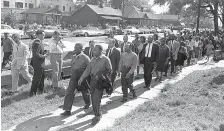  ?? AP PHOTO/HORACE CORT ?? Above: The Rev. Ralph Abernathy, left, and the Rev. Martin Luther King Jr. lead a column of demonstrat­ors as they attempt to march on Birmingham, Ala., city hall on April 12, 1963. Police intercepte­d the group short of their goal. Left: Civil rights veteran Charles Avery sits on the deck of his home in Center Point, Ala., on May 3. Arrested during a demonstrat­ion in 1963, Avery said he supports today’s protests against racial injustice.