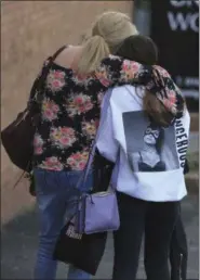  ?? THE ASSOCIATED PRESS ?? A fan is comforted as she leaves the Park Inn hotel in central Manchester, England on Tuesday.