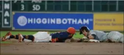  ?? RICHARD CARSON — THE ASSOCIATED PRESS ?? Yan Gomes is safe on a double while Astros second baseman Jose Altuve tries to make the tag in the second inning May 21 in Houston.