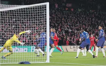  ?? ?? Liverpool captain Virgil van Dijk, third from left and partially obscured, heads the winning goal past Chelsea goalkeeper Djordje Petrovic at Wembley. GETTY IMAGES