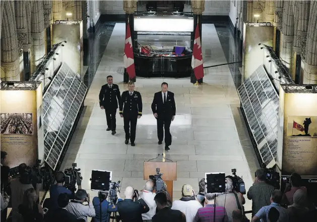  ?? Sean Kilpatrick/cana DIAN PRESS ?? From left, Chief Warrant Officer Serge Froment, Lt.-Gen. Stuart Beare and Defence Minister Peter MacKay arrive to unveil the travelling Afghanista­n Memorial Vigil on Parliament Hill in Ottawa on Tuesday. The memorial contains the plaques originally...