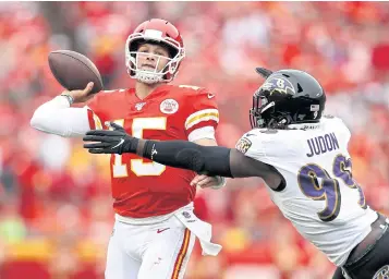  ?? AFP ?? Chiefs quarterbac­k Patrick Mahomes, left, throws a pass against the Ravens’ Matt Judon in Kansas City.