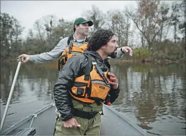  ?? Bethany Mollenkof Los Angeles Times ?? SCIENTISTS spot salmon in the San Joaquin River in 2013. New legislatio­n to counter federal deregulati­on efforts would continue California’s endless conf lict between farmers and salmon over access to water.