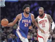  ?? AP ?? The 76ers’ Joel Embiid, left, tries to get past the Rockets’ Jeff Green during the first half on Monday in Philadelph­ia.