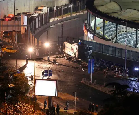  ??  ?? HORROR: Fire fighters and police cover the dead lying in the debris at the site of a car bomb explosion outside the stadium of football club Besiktas in central Istanbul last night