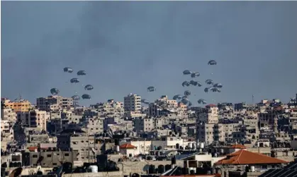  ?? Anadolu/Getty Images ?? Humanitari­an aid packages are dropped from a plane as Israeli attacks continue on the second day of Eid al-Fitr in Gaza City. Photograph: