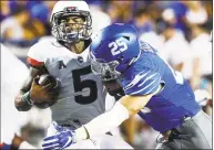  ?? Mark Weber / The Commercial Appeal via AP ?? Memphis defender Austin Hall, right, hits UConn quarterbac­k David Pindell during Saturday’s game.