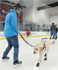  ??  ?? Emily Molchan skates with guide dog Remington.