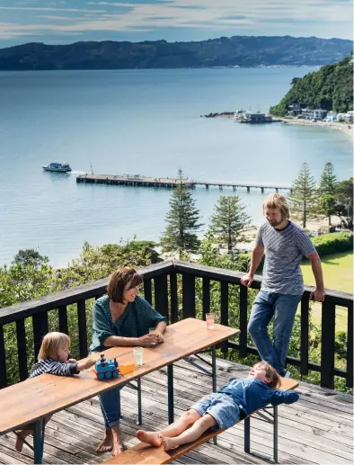  ??  ?? LEFT: Niels, Deborah and their two children Lars ( 7) and Romeo ( 3) spend a lot of time in summer on the deck, which looks out over Days Bay. The vintage German trestle table and benches came from The Vitrine in Auckland.