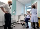  ?? GETTY IMAGES ?? Prime Minister Boris Johnson watches as junior sister Susan Cole is injected with the Oxford/ AstraZenec­a Covid-19 vaccine during a visit to Chase Farm Hospital, London.