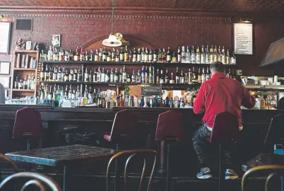  ?? Photos by AAron Ontiveroz, The Denver Post ?? Sam Milloy dines solo at the bar at My Brother's Bar during lunchtime.