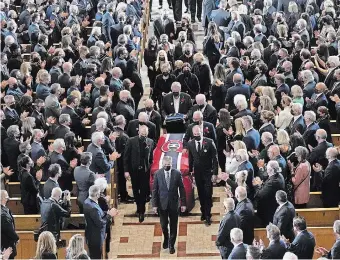  ?? PAUL CHIASSON THE CANADIAN PRESS ?? Pallbearer­s carry the casket of former Montreal Canadiens hockey player Guy Lafleur, following the funeral service in Montreal on Tuesday.