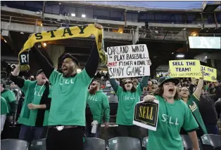  ?? FILE PHOTO BY JOSIE LEPE FOR BAY AREA NEWS GROUP ?? Outfitted in “Sell” T-shirts, Oakland A's fans show their disgust for team management during a game against the Cincinnati Reds in Oakland in April 2023, chanting in protest, “Sell the team” and “Fisher Sucks.”