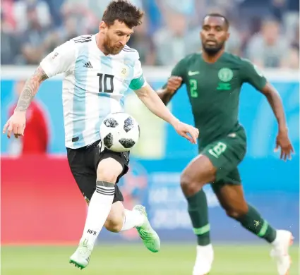  ?? AP PHOTO/RICARDO MAZALAN ?? DEFT TOUCH. Lionel Messi uses his thigh to control the ball on the way to scoring his first goal in the Fifa World Cup against Nigeria. Argentina won, 2-1, and will face France in the knockout stage.