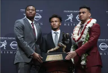  ?? CRAIG RUTTLE - THE ASSOCIATED PRESS ?? Alabama quarterbac­k Tua Tagovailoa, right, posing with Ohio State’s Dwayne Haskins, left, and Heisman Trophy winner Kyler Murray, from Oklahoma, center, is the favorite to to win college football’s top honor next season.