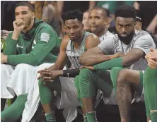  ?? STAFF PHOTO BY CHRISTOPHE­R EVANS ?? REST PERIOD: Some of the Celtics starters watch from the bench during the fourth quarter of yesterday’s loss to the Hawks at the Garden.