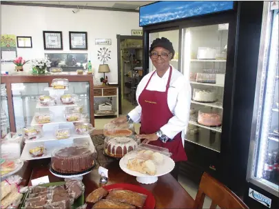  ?? Staff photo by Greg Bischof ?? ■ Beverly J. Daniels, owner of the Munchables Home Baked Goodness Bakery at 4424 W. Seventh Street, stands near an array of her baked goods which continue to sell well despite the continuing COVID-19 pandemic. To accommodat­e customers, Daniels installed a temporary business counter at the front of her store.