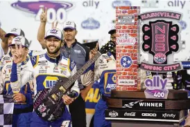  ?? MARK HUMPHREY/AP ?? Chase Elliott poses with his guitar and trophy after winning a NASCAR Cup Series auto race Sunday in Lebanon, Tenn.