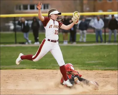  ?? Brian A. Pounds / Hearst Connecticu­t Media ?? Masuk’s Natalie Lieto steals second base as St. Joseph’s Niamh Dougherty grabs a high throw during Thursday’s game in Trumbull.