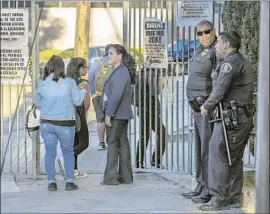  ?? Irfan Khan Los Angeles Times ?? POLICE keep watch at Sal Castro Middle School on Friday. The campus resumed a normal schedule, with counseling services and substitute teachers available.