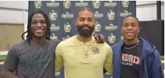  ?? The Sentinel-Record/Donald Cross ?? ■ Hot Springs’ Zamarion Wilson, left, and Kivan Barker, right, celebrate with Hot Springs head coach Darrell Burnett after signing to play collegiate football.