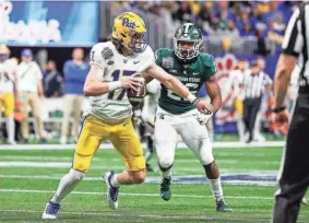  ?? JUNFU HAN/USA TODAY NETWORK ?? Pittsburgh quarterbac­k Davis Beville scrambles away from a Michigan State player during the Peach Bowl last December. Beville has transferre­d to Okahoma.