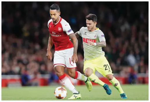 ??  ?? Arsenal’s English midfielder Theo Walcott, left, vies with FC Cologne’s German midfielder Leonardo Bittencour­t during the UEFA Europa League Group H football match between Arsenal and FC Cologne in London on Thursday. (AFP)