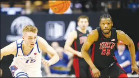  ?? STEVE MARCUS ?? Boise State guard Jace Whiting (15) and UNLV guard EJ Harkless (55) chase after a loose ball during a 2023 game in Las Vegas. Whiting has entered the transfer portal and is getting a look from UNLV.
