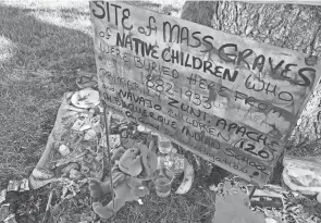  ?? SUSAN MONTOYA BRYAN/AP FILE ?? A makeshift memorial for the dozens of Indigenous children who died more than a century ago while attending a boarding school that was once located nearby is displayed under a tree at a public park in Albuquerqu­e, N.M., last year.