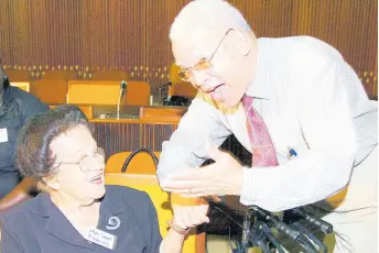  ?? FILE ?? Sybil Francis (left), former director of the Social Welfare Training Centre and chairman of the National Council for Senior Citizens, shares a light moment with Clinton Davis, president of the Jamaica Government Pensioners’ Associatio­n, at the disclosure of the National Consultati­on on Survey Results of Older Persons in Selected Communitie­s held at the Jamaica Conference Centre in Kingston in an undated Gleaner photo.