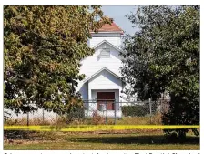  ?? SCOTT OLSON/GETTY IMAGES ?? Crime scene tape remains stretched near the First Baptist Church of Sutherland Springs on Tuesday in Sutherland Springs, Texas, the site of a mass shooting Sunday.