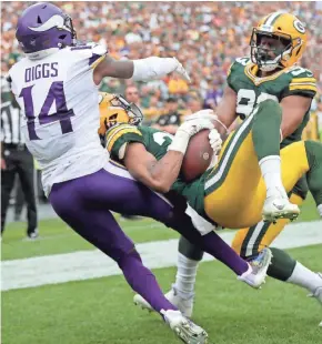  ?? WM. GLASHEEN/USA TODAY NETWORK ?? Packers cornerback Kevin King intercepts a pass in the end zone that was intended for Vikings wide receiver Stefon Diggs (14) during the fourth quarter on Sunday at Lambeau Field.